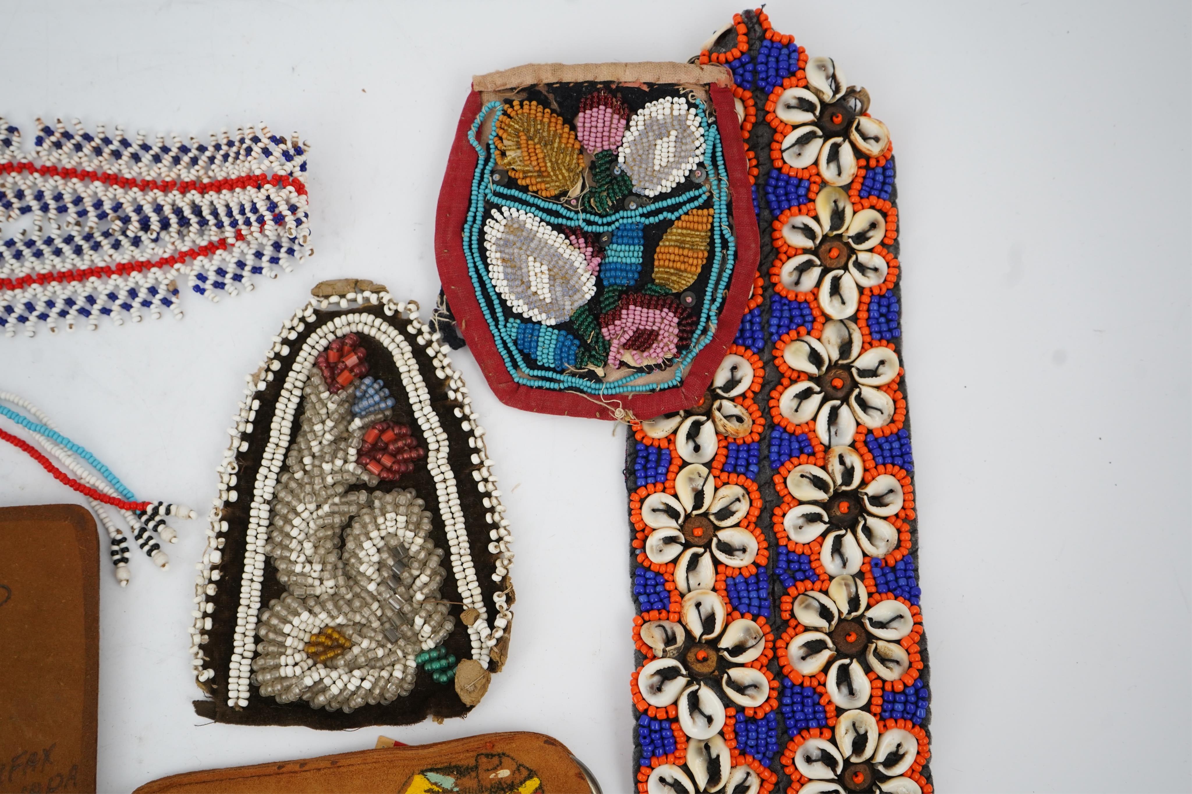 A collection of mixed decorative bead work, including five items of Native American beadwork, together with an early beadwork bag and later beaded items. Condition - moccasins, bead panel, circular bed purse with metal l